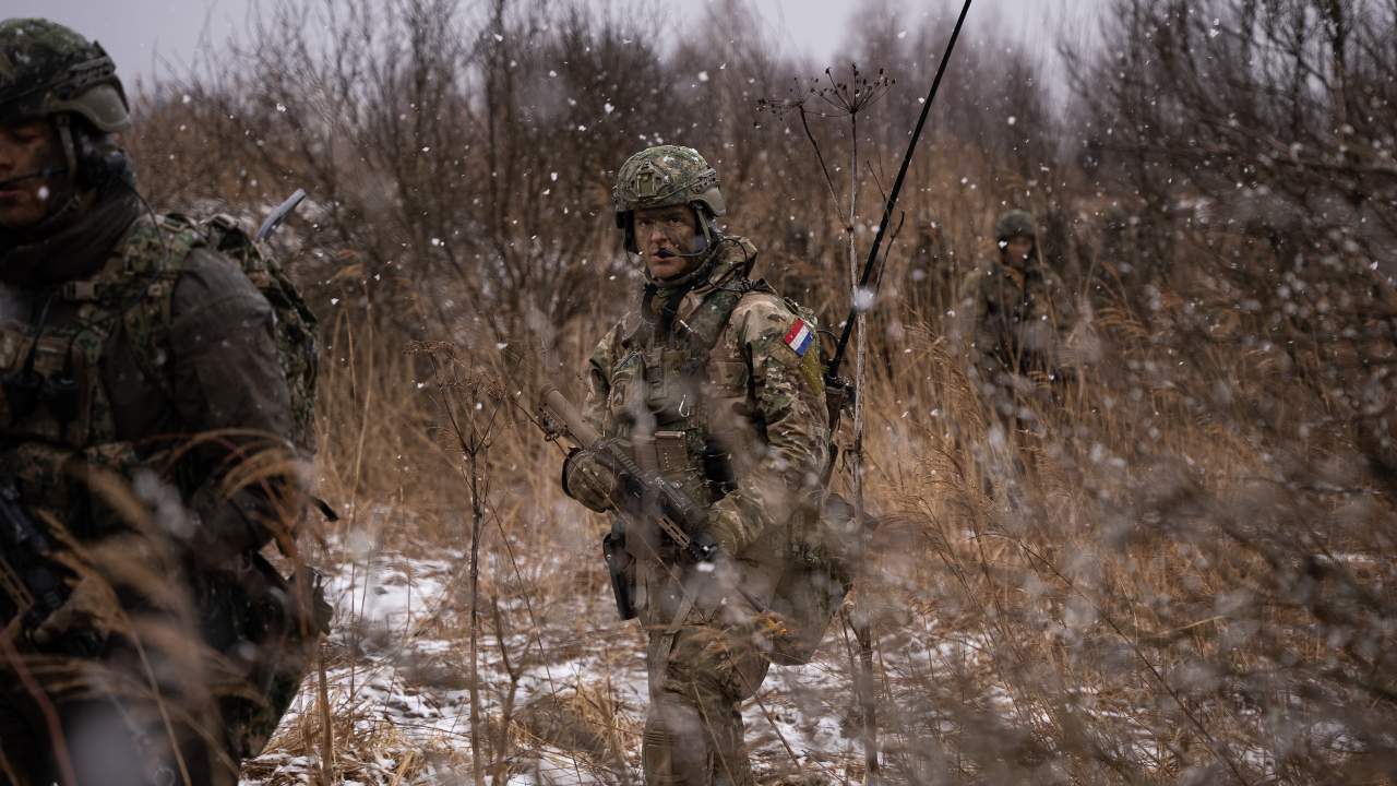 Photo: A line of mechanised infantry from the Royal Netherlands Army’s 42nd Armoured Infantry Battalion moves through marshy ground during Exercise Rising Griffin 2022. Credit: NATO