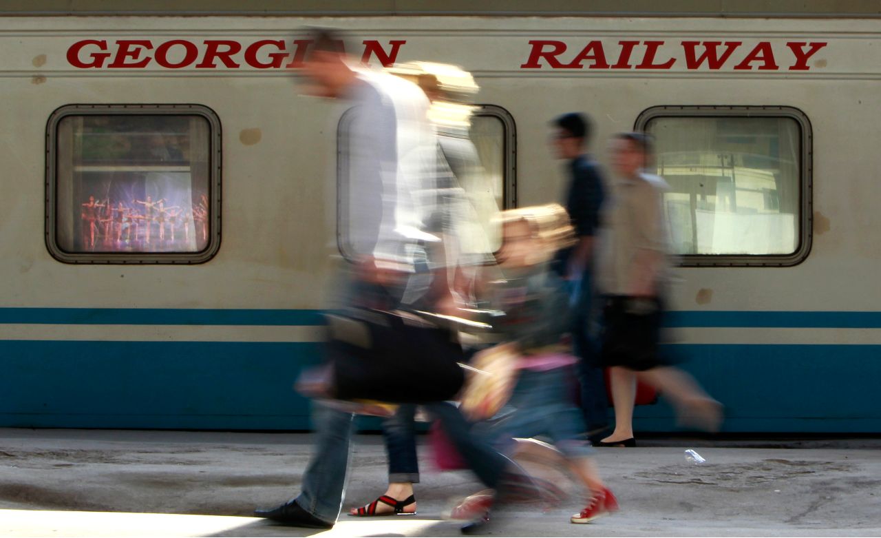 Photo: Passengers walk past a Georgian Railway train at the railway station in Tbilisi, June 6, 2012. Georgia postponed a planned London listing of its state railways monopoly in May, dealing a fresh blow to IPO markets as investors struggle with volatile share prices and reel from the debacle of Facebook's flotation. Picture taken June 6. Credit: REUTERS/David Mdzinarishvili
