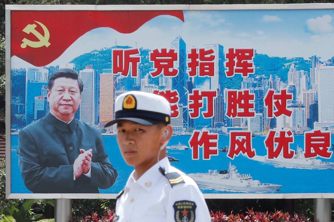 Photo: A People's Liberation Army Navy soldier stands in front of a backdrop featuring Chinese President Xi Jinping during an open day of Stonecutters Island naval base, in Hong Kong, China, June 30, 2019. Credit: REUTERS/Tyrone Siu