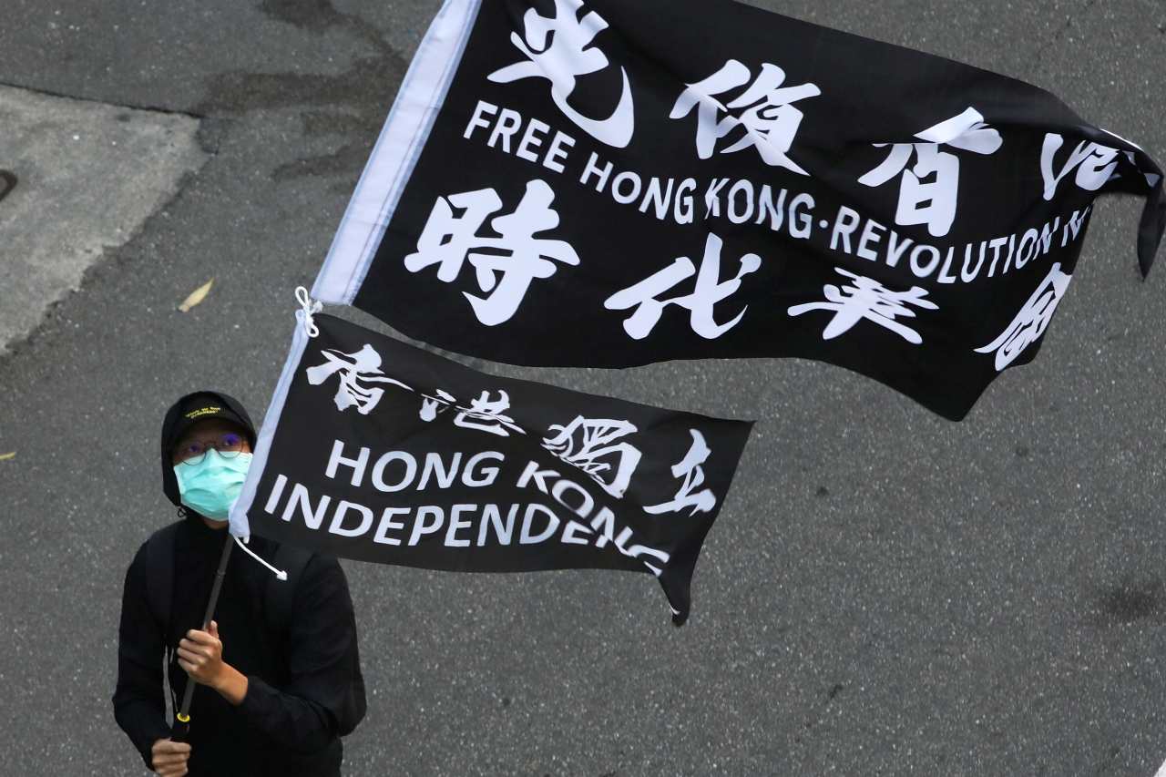 Photo: A protester holds a "Free Hong Kong revolution" flag during a rally calling China to release 12 Hong Kong people arrested at sea by mainland authorities, in Taipei, Taiwan, October 25, 2020. Credit: REUTERS/Ann Wang
