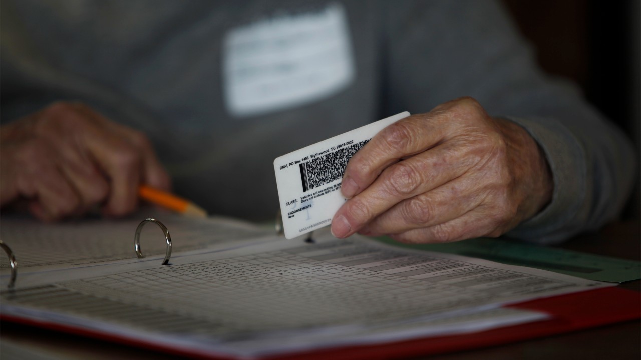 Photo: A precinct worker checks a voter ID at the Bermuda precinct for the U.S. presidential election in Dillon, South Carolina, November 8, 2016. Credit: REUTERS/Randall Hill