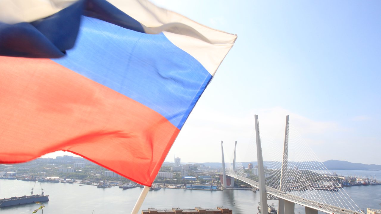 Photo: A Russian national flag flutters in front of a general view of a new bridge over the Golden Horn bay in the Russian far-eastern city of Vladivostok September 10, 2012. Credit: REUTERS/Sergei Karpukhin.