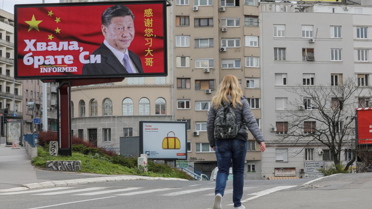 Photo: A woman passes by a billboard depicting Chinese President Xi Jinping as the spread of the coronavirus disease (COVID-19) continues in Belgrade, Serbia, April 1, 2020. The text on the billboard reads "Thanks, brother Xi". Picture taken April 1, 2020. Credit: REUTERS/Djordje Kojadinovic