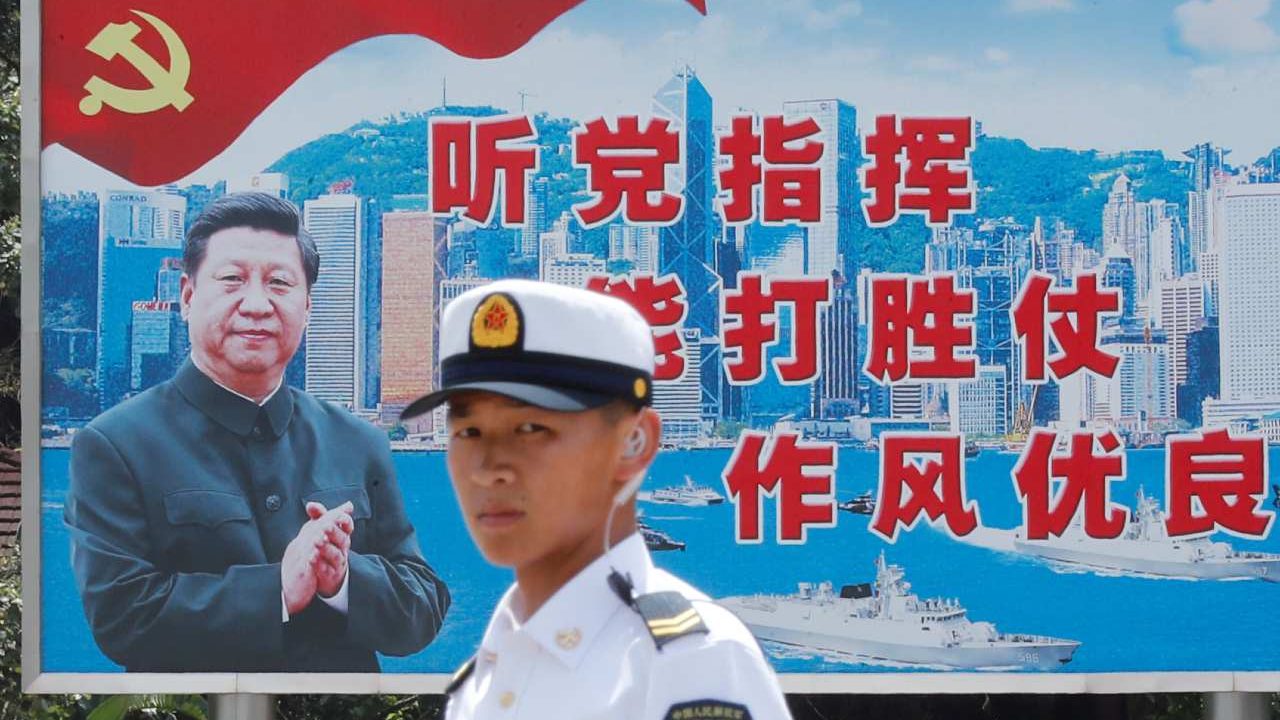 Photo: A People's Liberation Army Navy soldier stands in front of a backdrop featuring Chinese President Xi Jinping during an open day of Stonecutters Island naval base, in Hong Kong, China, June 30, 2019. Credit: REUTERS/Tyrone Siu