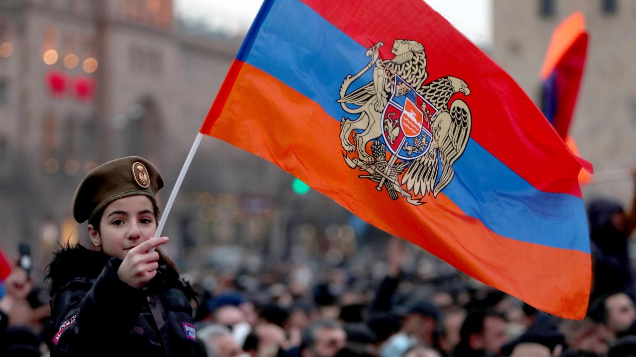 Photo: YEREVAN, ARMENIA - MARCH 1, 2021: A girl holds an Armenian flag during a rally in support of Armenian Prime Minister Nikol Pashinyan outside the Armenian Government House in Republic Square. Credit: Hayk Baghdasaryan/Photolure/TASS