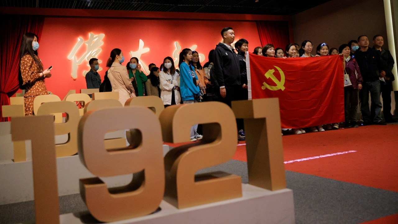 Photo: People hold the Chinese national flag as they pose for a group picture at an exhibition marking the 100th founding anniversary of the Chinese Communist Party (CCP) in Beijing, China, April 22, 2021. Credit: REUTERS/Thomas Peter