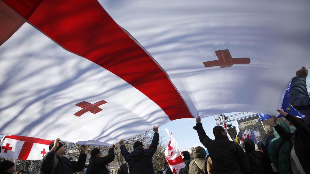 Photo: TBILISI, GEORGIA - DECEMBER 2, 2021: Former president Mikheil Saakashvili's supporters unfold a large Georgian flag as they rally outside the Tbilisi City Court during a hearing into his embezzlement case. He faces charges of embezzling some 9mln laris [~$2.9mln] in state funds in 2014. Earlier Saakashvili returned to Georgia shortly before the first round of local elections and was immediately taken into custody. Credit: David Mdzinarishvili/TASS.No use Russia.