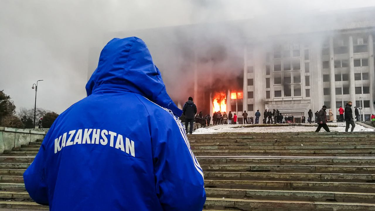 Photo: ALMATY, KAZAKHSTAN - JANUARY 5, 2022: People rally outside the burning mayor’s office. Protests are spreading across Kazakhstan over the rising fuel prices; protesters broke into the Almaty mayor’s office and set it on fire. Credit: Yerlan Dzhumayev/TASS.