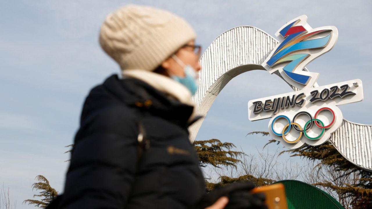 Photo: A woman walks past the Beijing 2022 Winter Olympic logo at an installation featuring National Speed Skating Oval, in Beijing, China January 18, 2022. Credit: REUTERS/Carlos Garcia Rawlins