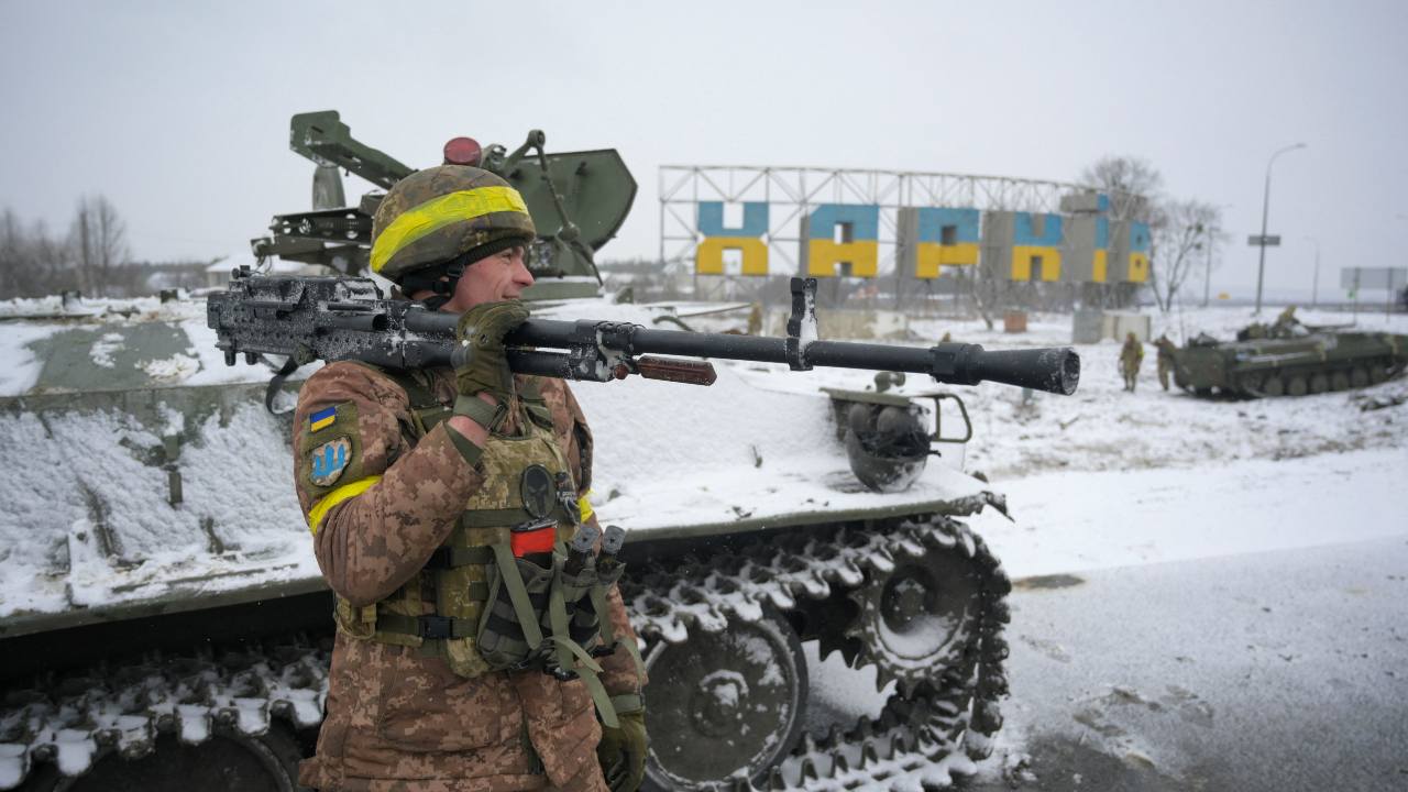 Photo: A Ukrainian serviceman reacts while holding a weapon in Kharkiv, Ukraine February 25, 2022. Credit: REUTERS/Maksim Levin