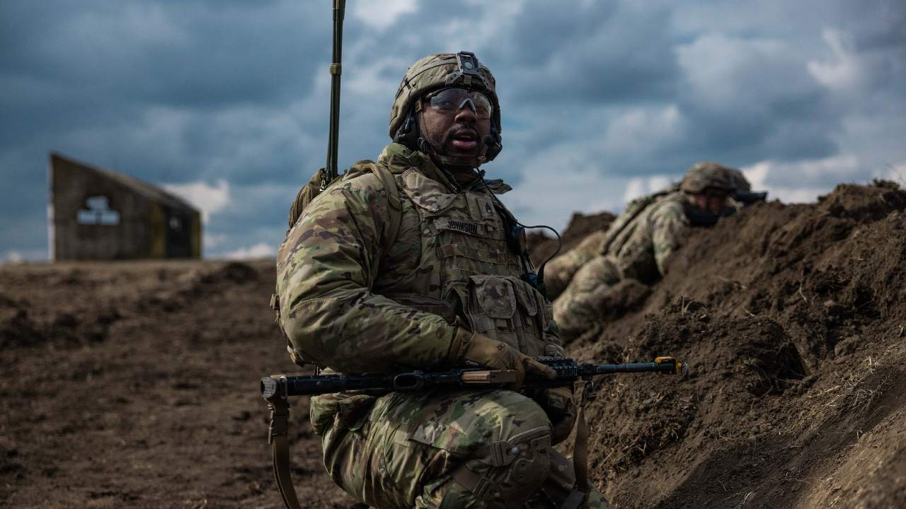 Photo: A squad leader with the US Army’s Second Squadron, 2nd Cavalry Regiment surveys his soldiers during a blank-fire exercise at Smârdan Training Area in Romania on 8 March 2022. Credit: NATO.