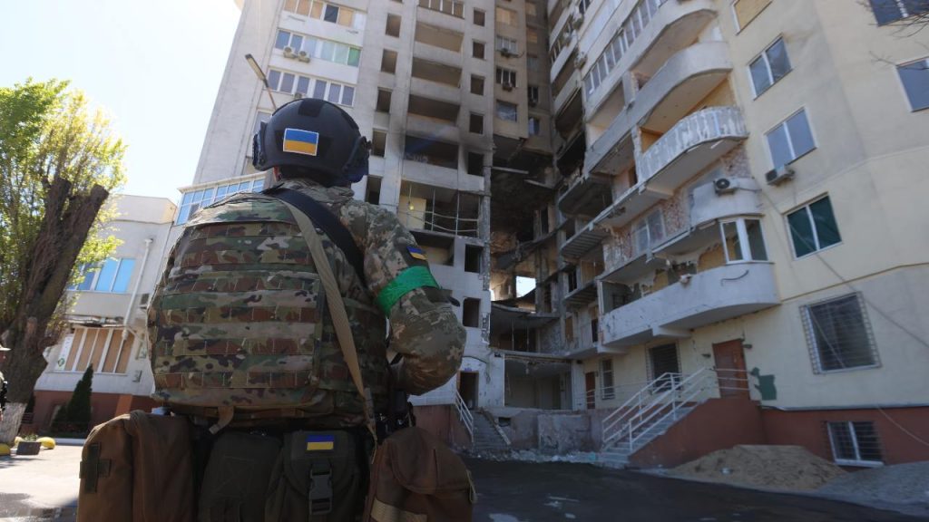 Photo: Ukrainian soldier gazes at a bombed apartment building Odesa during a visit by European Council President Charles Michel. Credit: European Council.