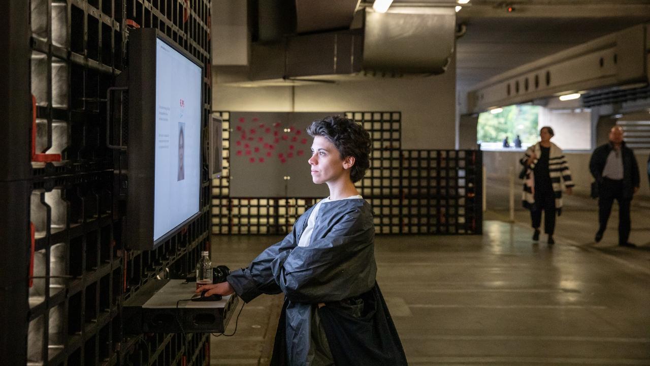 Photo: A woman explores an interactive exhibit on facial recognition and bias. Credit: Jürgen Grünwald/Creative Commons.