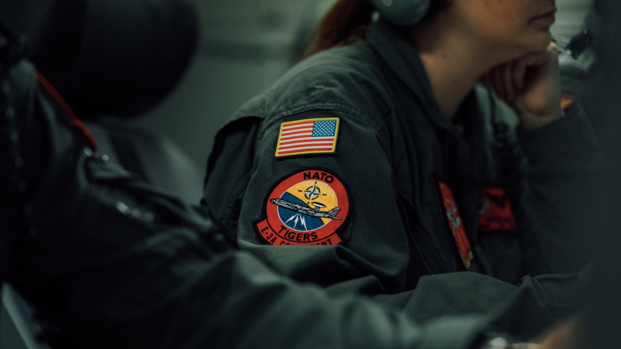 Photo: Two patches on the arm of an American crew member of a NATO Boeing 707 E-3A AWACS. Credit: NATO via Flickr.