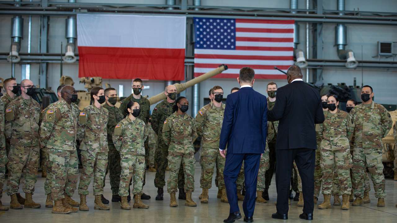 Photo: U.S. Secretary of Defense, Lloyd J. Austin III, and Mariusz Błaszczak, Minister of National Defense of Poland greet the troops during a visit to Powidz Air Base, Poland, Feb. 18, 2022. During his remarks, Austin focused on enhancing bilateral cooperation and deepening the Polish-American partnership. Credit: Sgt. Agustín Montañez/US Army National Guard