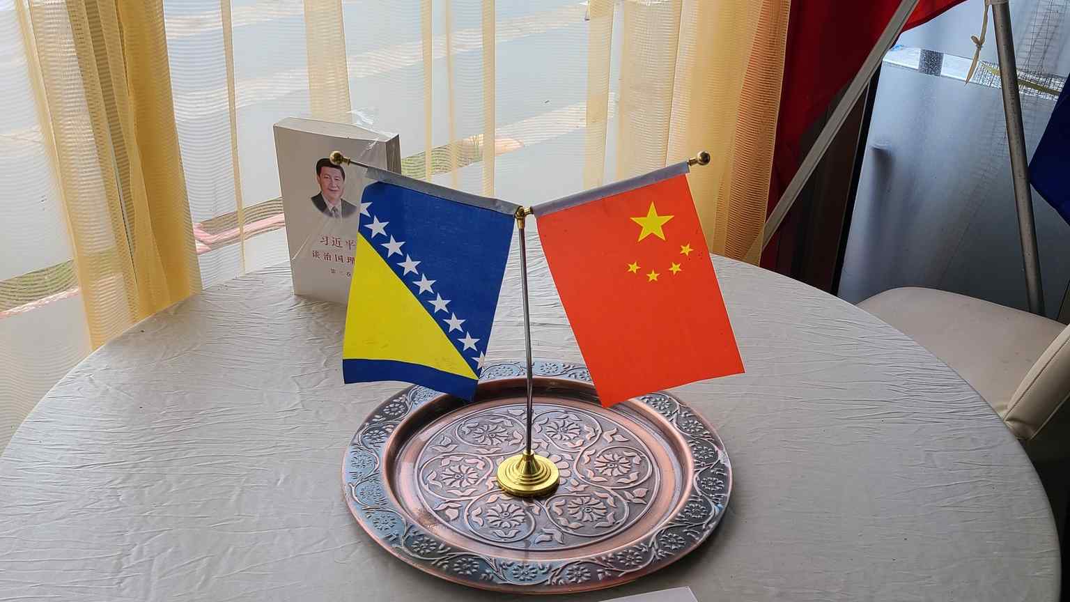 Photo: Bosnia and Herzegovina and the People's Republic of China's flags in a cafe in Bosnia and Herzegovina. Credit: Masha Borak, Twitter, August 27, 2022.