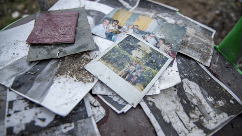 Photo: Picture of photographs and a passport illustrating the Dutch forensic investigations into war crimes. Credit: Royal Netherlands Marechaussee/ Netherlands Ministry of Defence.
