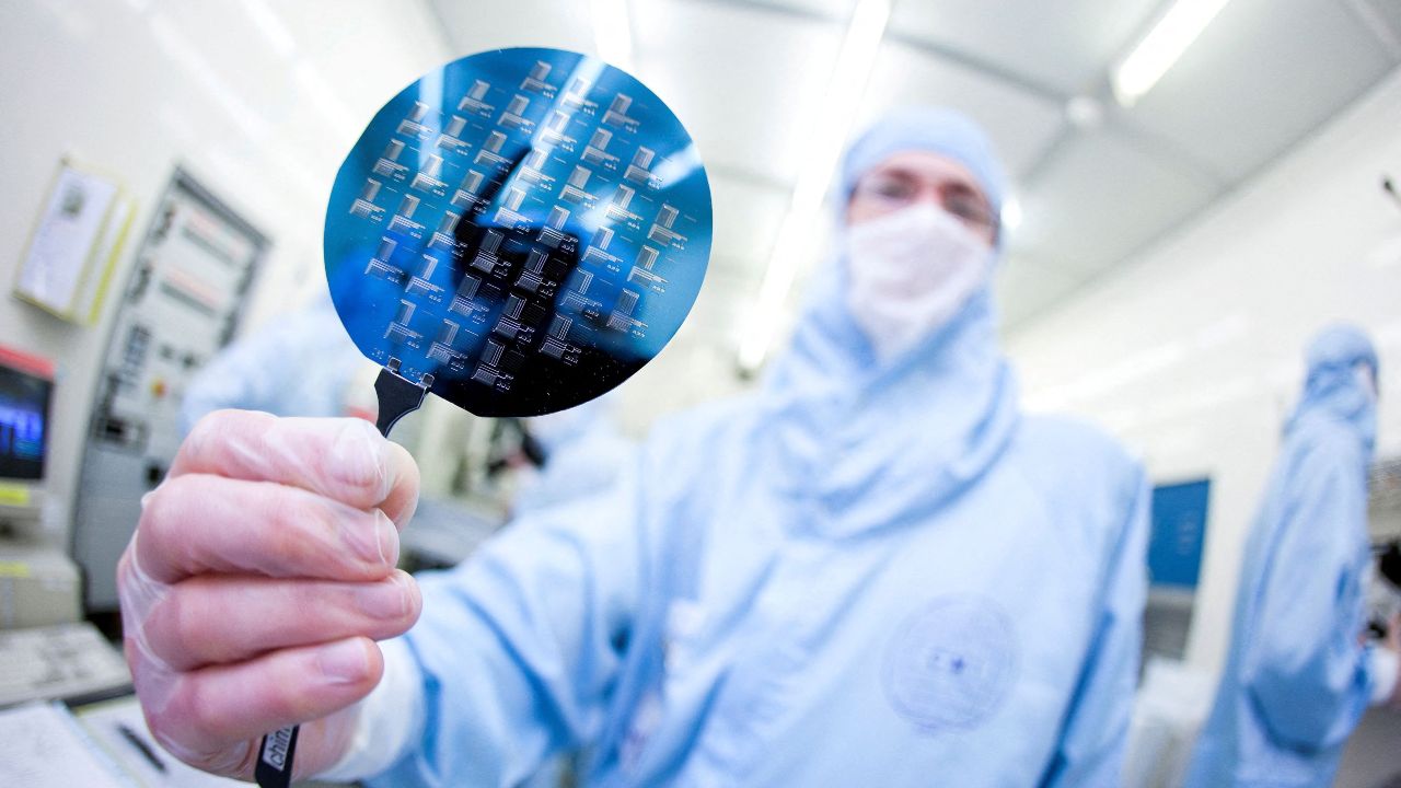 Photo: A scientist presents a silicon wafer during a media presentation in one of the low particle pollution nanofabrication clean rooms of the Swiss Federal Institute of Technology (EPFL) in Ecublens, near Lausanne May 16, 2011. Credit: REUTERS/Valentin Flauraud/File Photo