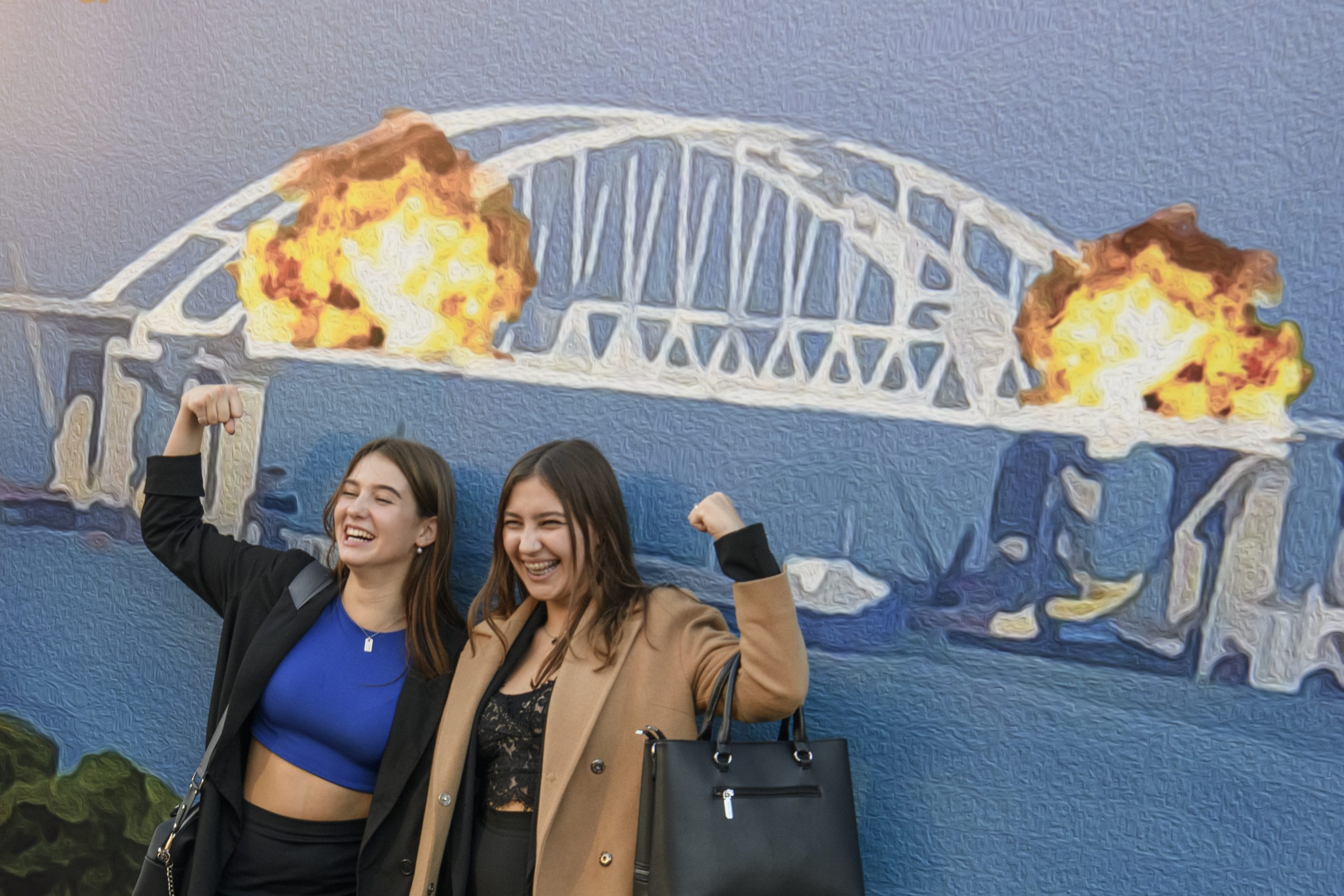 Photo: People pose for photos and take selfies in front of the large poster form of postage stamp depicting the Crimean Kerch Bridge on fire in Kyiv, Ukraine, October 08, 2022. Credit: Maxym Marusenko/NurPhoto