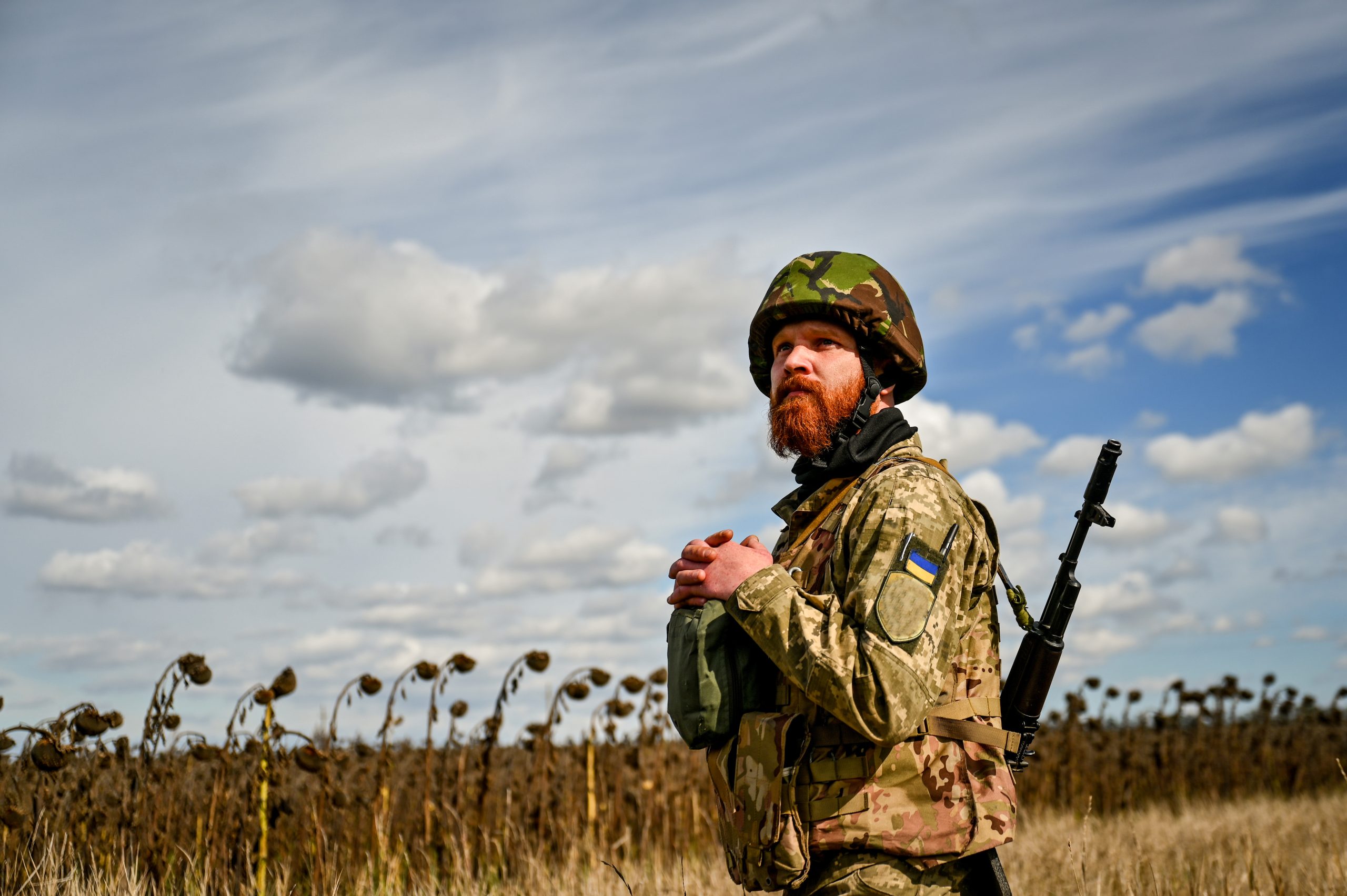 Photo: ZAPORIZHZHIA REGION, UKRAINE - OCTOBER 05, 2022 - A soldier of a military mortar crew stands on the border of a dry sunflower field, Zaporizhzhia Region, southeastern Ukraine. Credit: Dmytro Smoliyenko via Reuters Connect