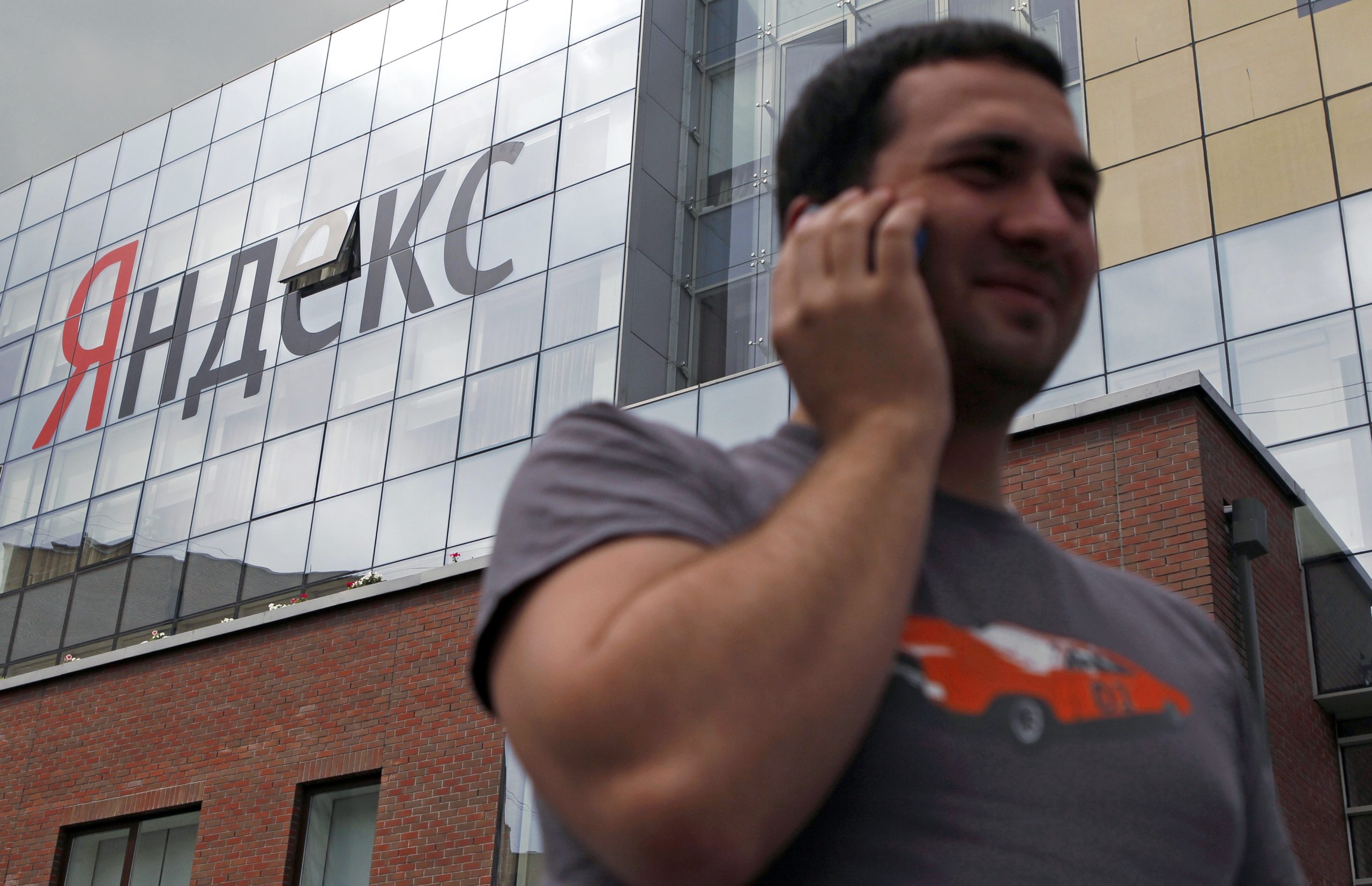 Photo: A man speaks on a mobile phone outside the headquarters of Yandex company in Moscow June 14, 2012. Credit: REUTERS/Maxim Shemetov