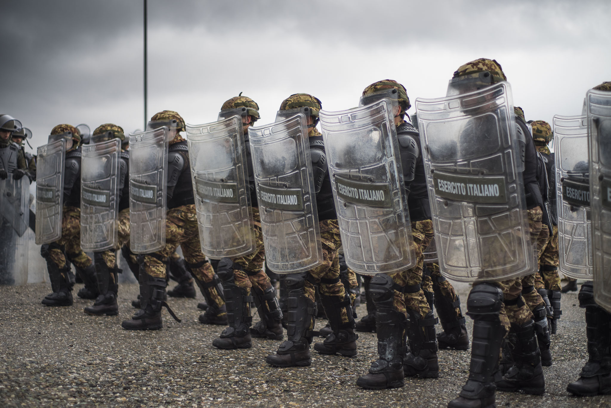 Photo: Kosovo: Multinational Battle Group West Italian soldiers of the Multinational Battel Group West lined up in front and with raised shields during a phase of crowd control training. Credit: Italian Ministry of Defense via Flickr https://flic.kr/p/238Akrg