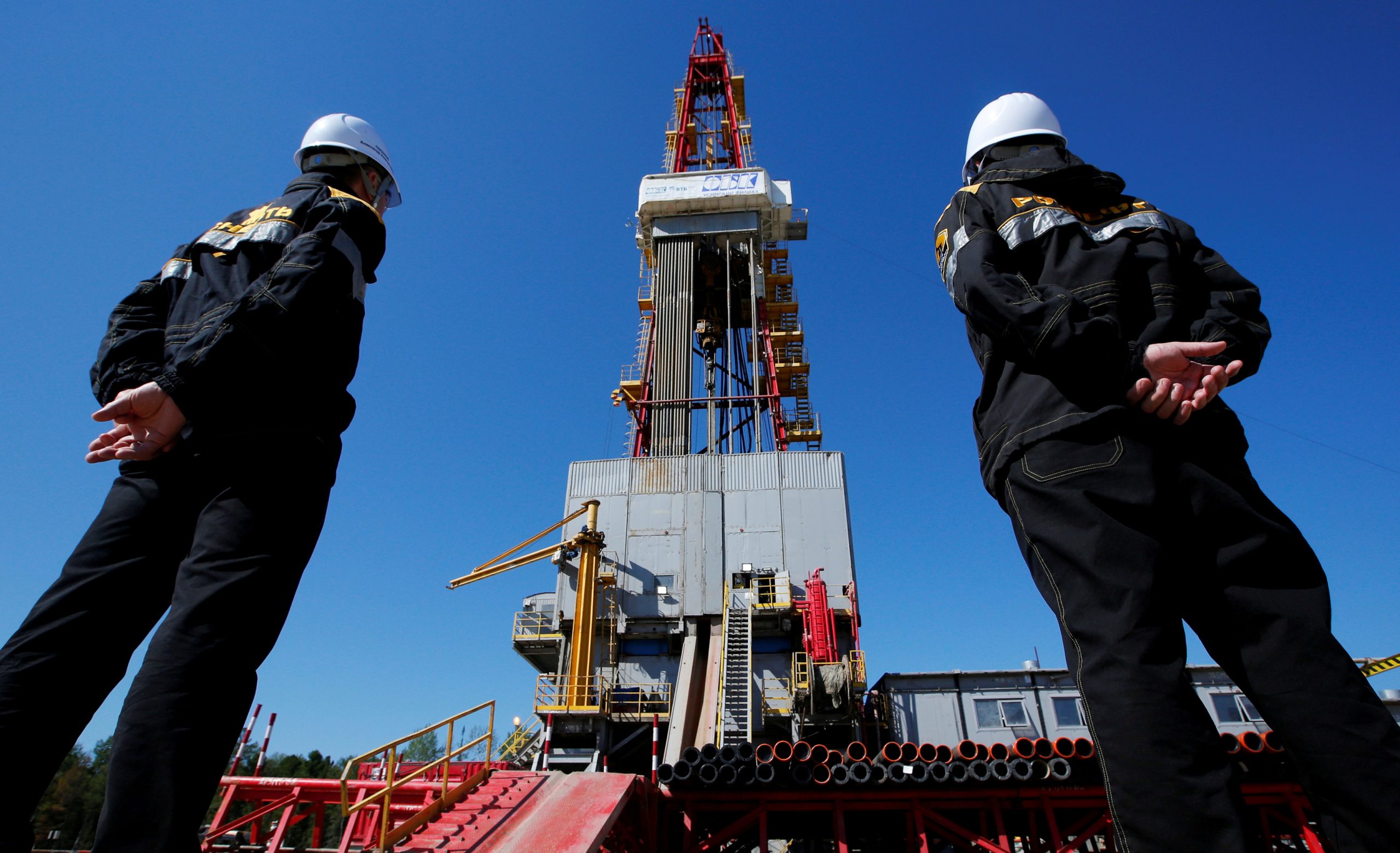 Credit: Workers look at a drilling rig at a well pad of the Rosneft-owned Prirazlomnoye oil field outside the West Siberian city of Nefteyugansk, Russia, August 4, 2016. Credit: REUTERS/Sergei Karpukhin/File Photo
