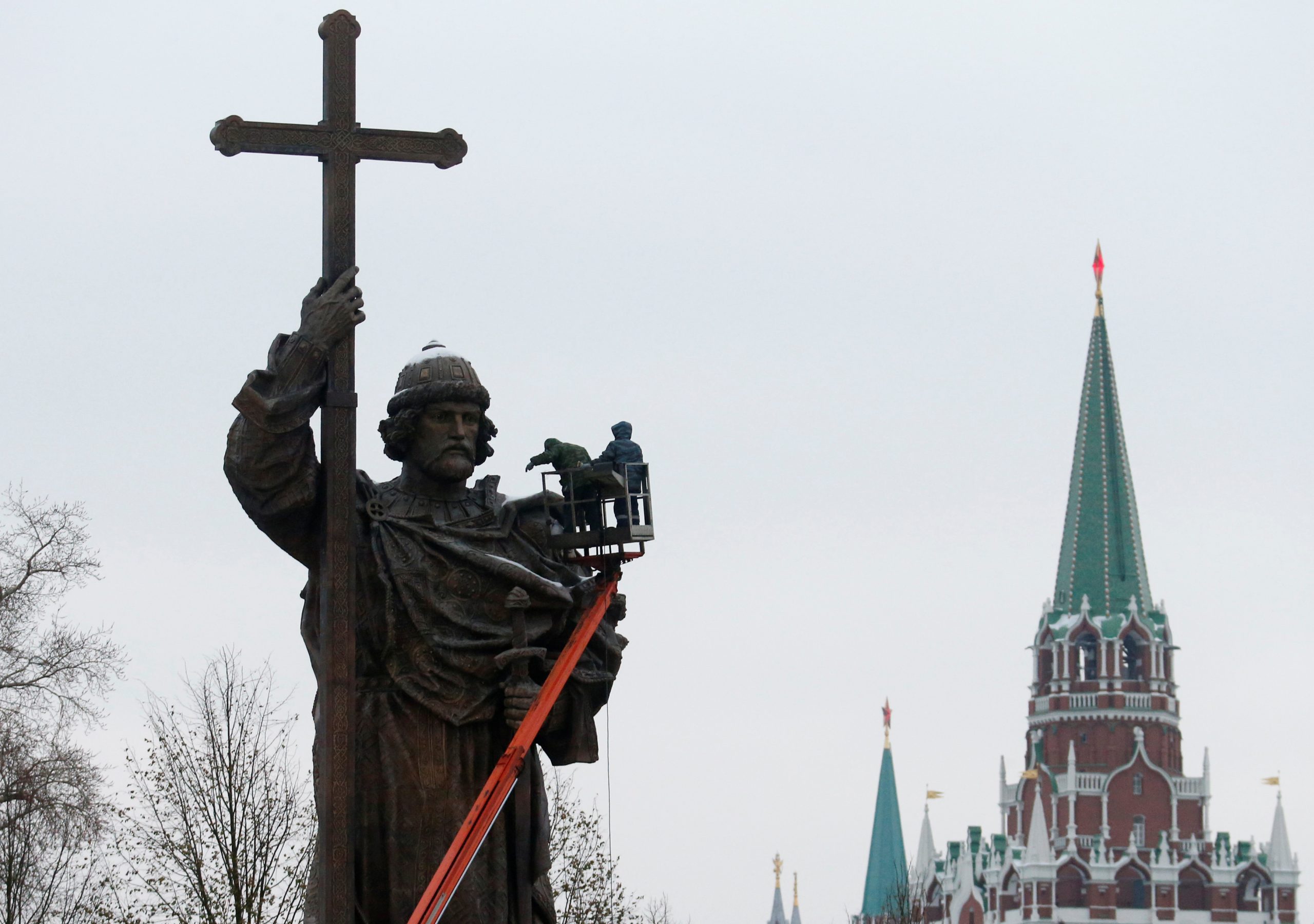 Photo: Employees work on the newly erected monument of grand prince Vladimir I, who initiated the christianization of Kievan Rus' in 988AD, with towers of the Kremlin seen in the background, in central Moscow, Russia, November 2, 2016. Credit: REUTERS/Maxim Zmeyev