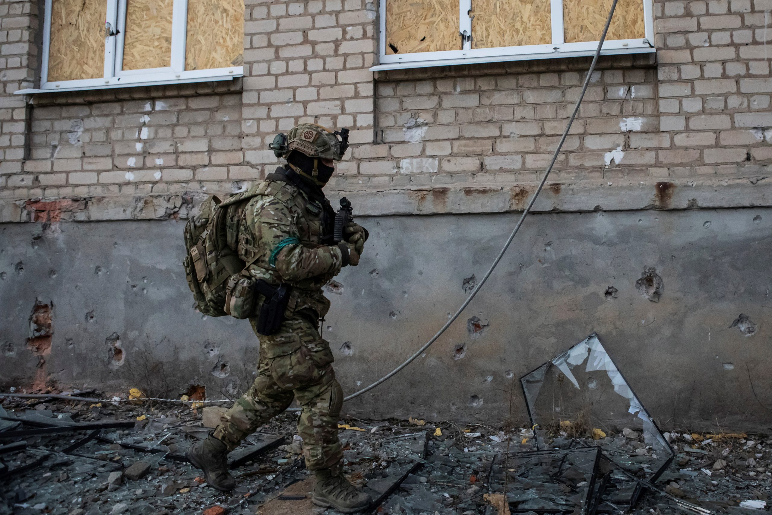 Photo: A Ukrainian serviceman walks along a building in the frontline town of Bakhmut, amid Russia's offensive in Ukraine, in Donetsk region, Ukraine February 9, 2023. Credit: REUTERS/Yevhenii Zavhorodnii