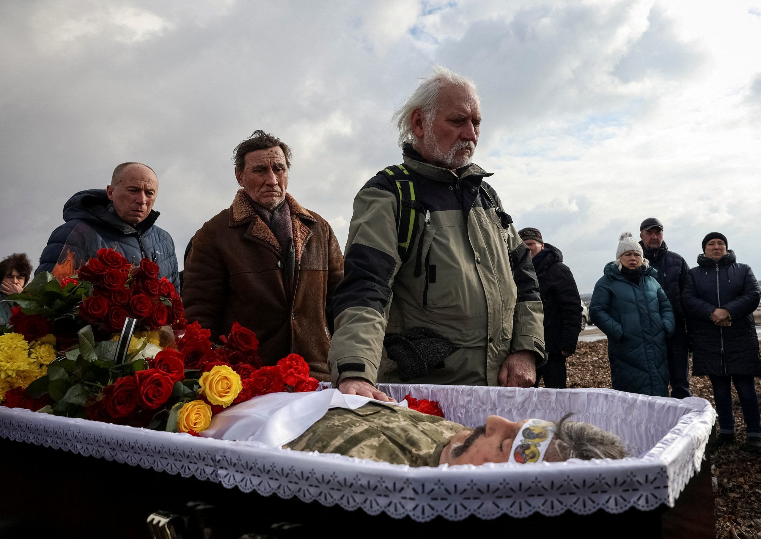 Photo: Relatives and friends react next to a coffin with the body of Ukrainian serviceman Hennadii Kovshyk, who was recently killed in a fight against Russian troops, amid Russia's attack on Ukraine, during a funeral ceremony at a cemetery in Kharkiv, Ukraine February 16, 2023. Credit: REUTERS/Sofiia Gatilova.