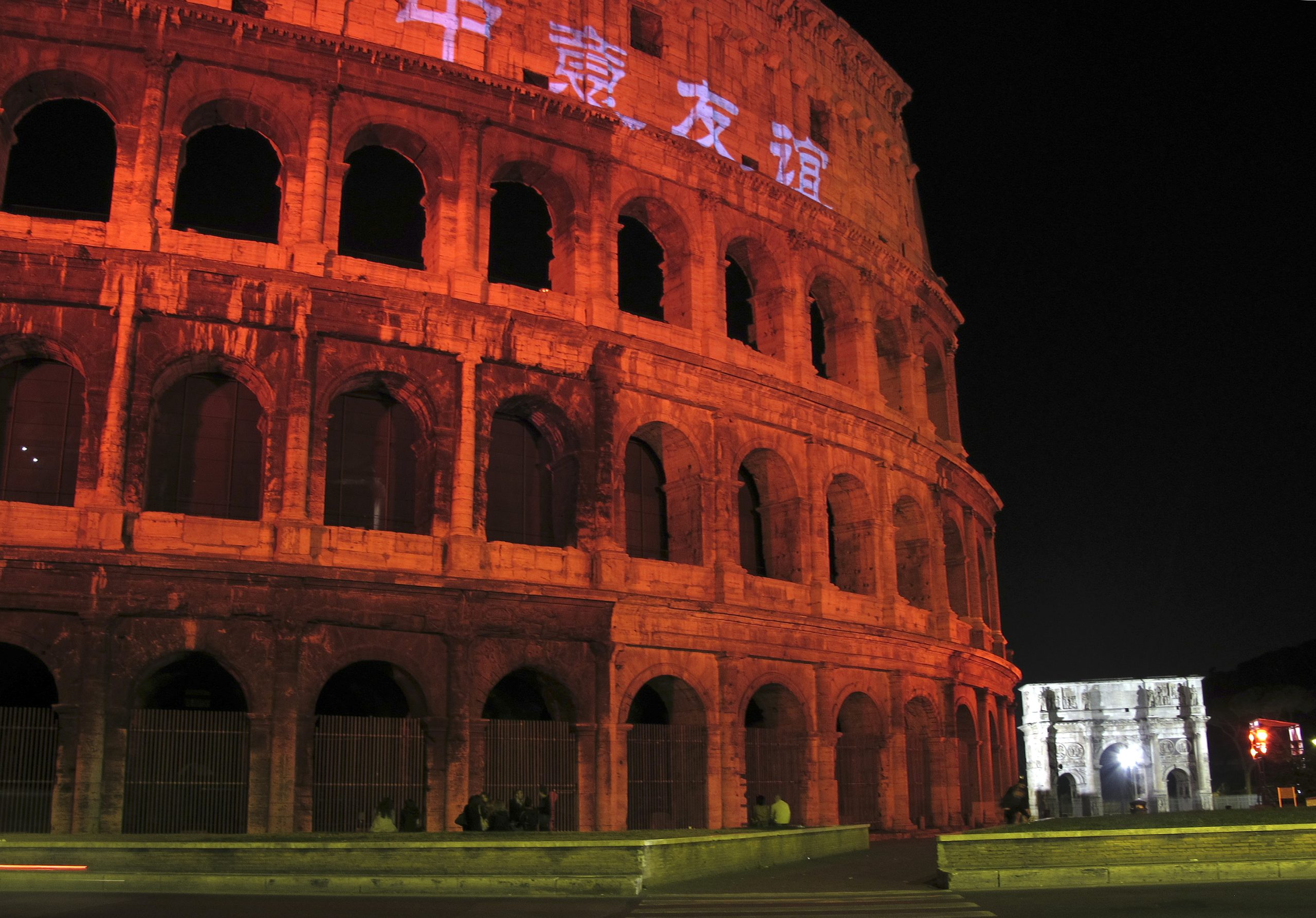 Photo: The facade of the Colosseum is bathed in red light and decorated with Chinese words during an economic summit in Rome October 8, 2010. Italy and China aim to more than double the annual value of their trade to as much as $100 billion by 2015, Chinese Premier Wen Jiabao said on Thursday after a meeting with Italian Prime Minister Silvio Berlusconi. The words on the Colosseum read, "Sino-Italian friendship". Credit: REUTERS/Alessandro Bianch