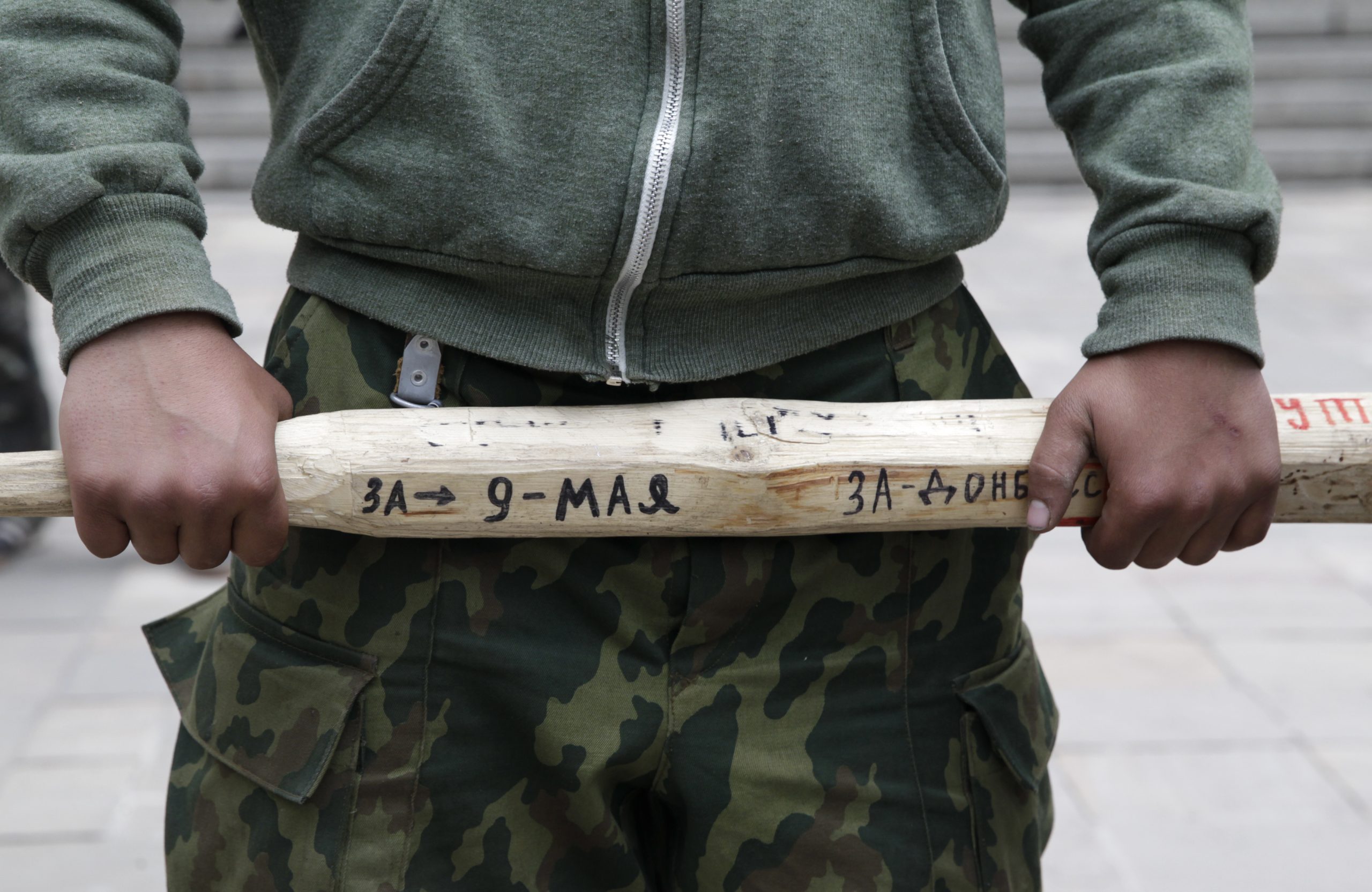 Photo: A man holds a stick outside the regional government headquarters in Luhansk, eastern Ukraine, April 29, 2014. Credit: REUTERS/Vasily Fedosenko