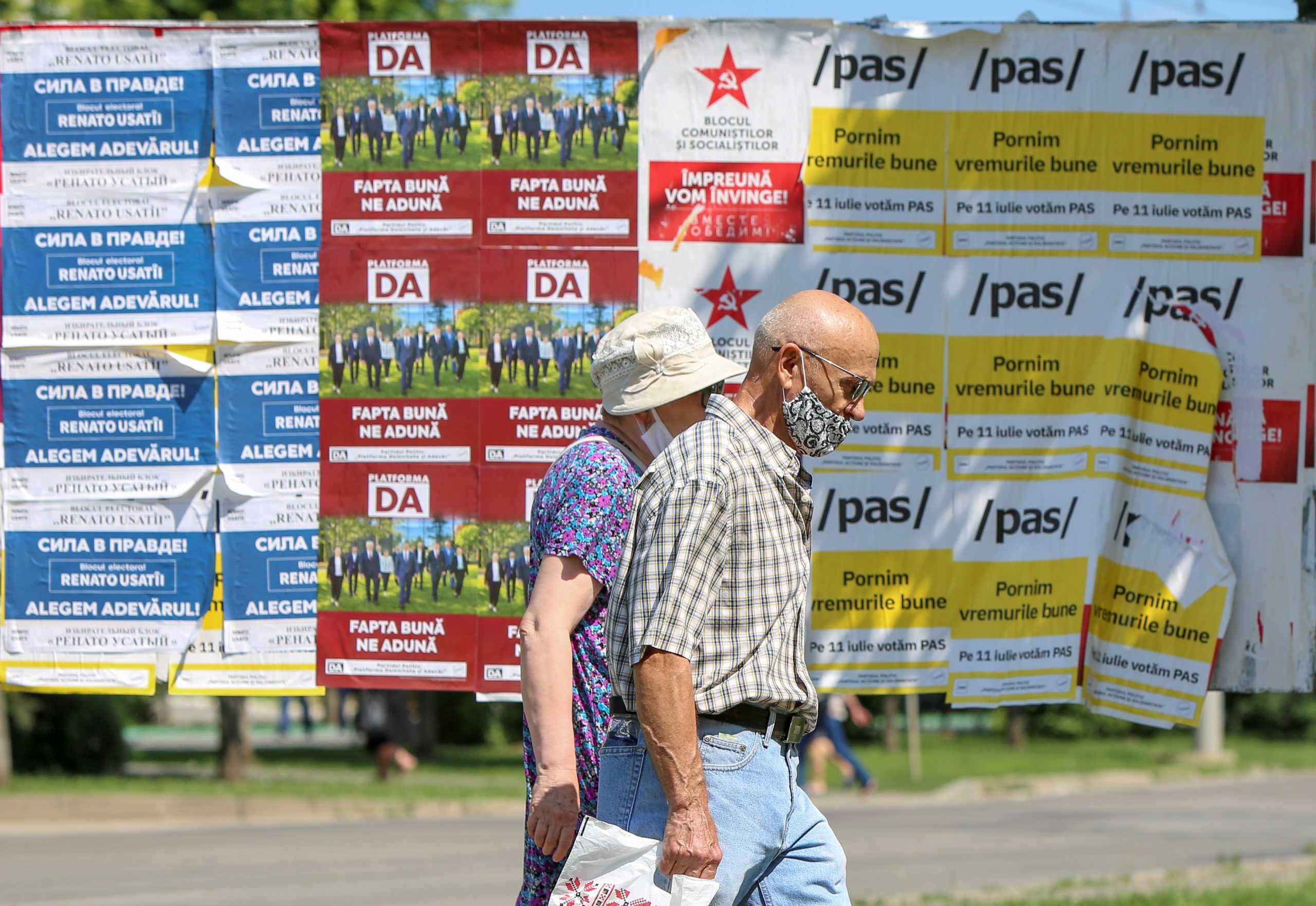 Photo: People walk past election campaign posters ahead of snap parliamentary election, scheduled on July 11, in Chisinau, Moldova July 7, 2021. Credit: REUTERS/Vladislav Culiomza