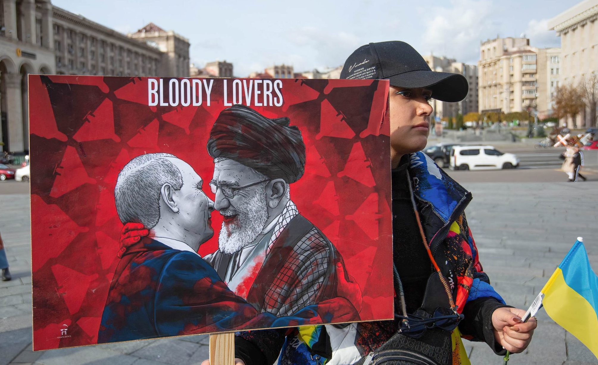 Photo: An Iranian woman who lives in Ukraine, holds a placard with the likenesses of Russian President Vladimir Putin and Iranian Supreme Leader Ali Khamenei during a protest against Iran's government and deliveries of Iranian drones to Russia in central Kyiv. Credit: Oleksii Chumachenko / SOPA Images/Sipa USA