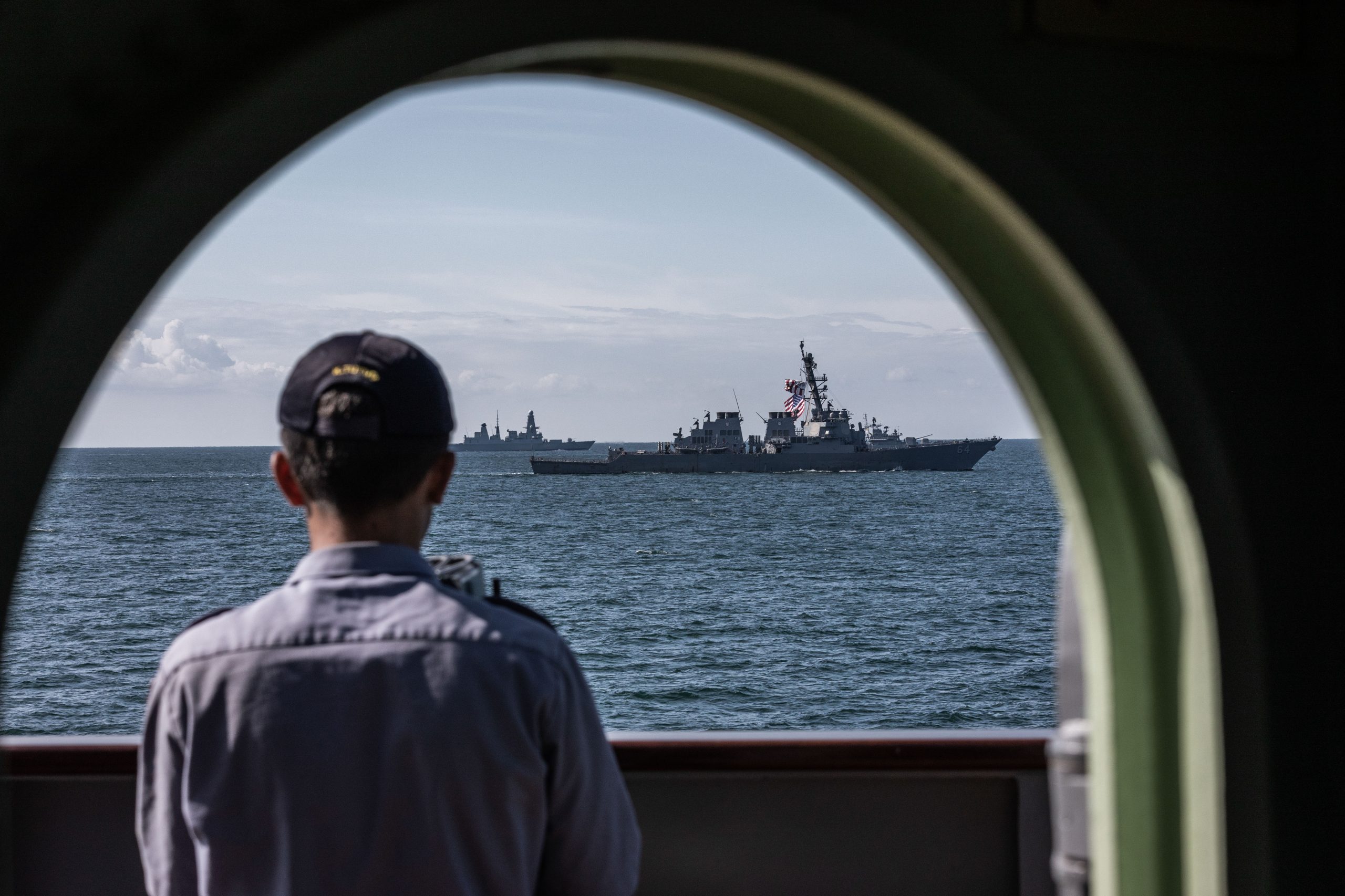 Photo: A Turkish sailor watches a formation of warships from the frigate TCG Turgutreis during Exercise Sea Breeze 2019. Credit: NATO via Flickr. https://flic.kr/p/2gH7pYB